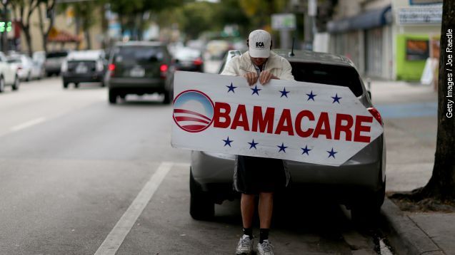 A man holds a sign directing people to an insurance company where they can sign up for the Affordable Care Act, also known as Obamacare, before the February 15th deadline on February 5, 2015 in Miami, Florida.