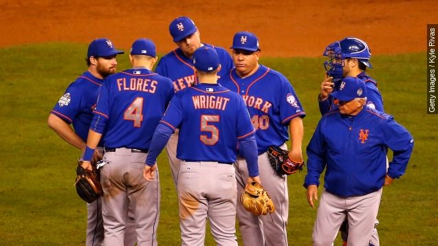 Dominican pitcher Bartolo Colon visits with his Mets teammates on the mound.