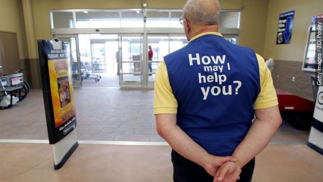 A Wal-Mart greeter waits to welcome new customers to the new 2,000 square foot Wal-Mart Supercenter store May 17, 2006 in Bowling Green, Ohio.