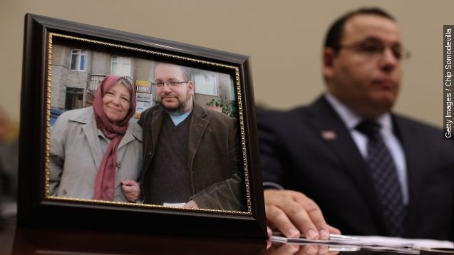 A photo of Washington Post journalist Jason Rezaian - who was imprisoned in Iran for over 500 days - sits next to his brother Ali Rezaian as he testifies before the House Foreign Affairs Committee.