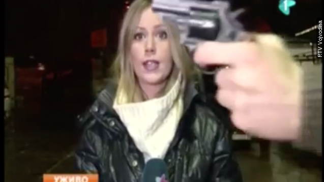 The moment a gun was flashed during a RTV Vojvodina broadcast delivered by Tamara Bojic.