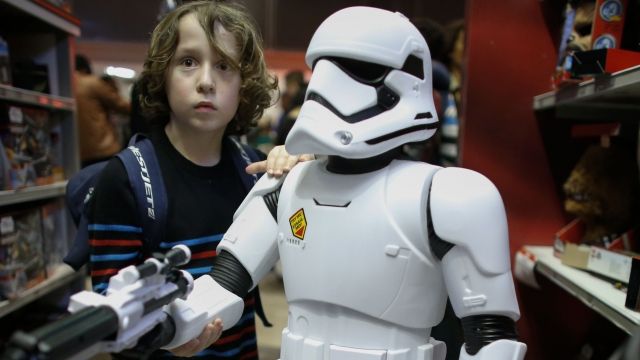 Boys play with a Stormtrooper toy from Star Wars at a Toys'R'Us store on December 24, 2015 in New York City.
