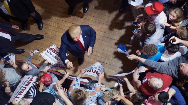 Donald Trump signs autographs at a campaign event