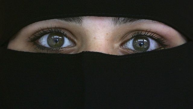 A Muslim woman wearing a Niqab poses inside an Asian fashion shop in the British northern town of Blackburn, the constituency of Member of Parliament Jack Straw, where a quarter of his constituents are Muslim on October 6, 2006, Blackburn, England.
