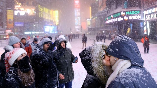 Couple kissing in blizzard