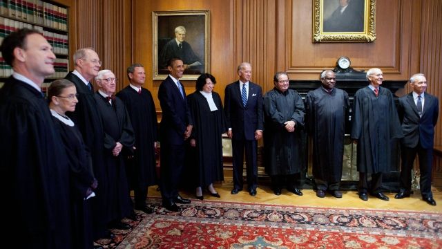 President Obama and Vice President Biden stand with the Supreme Court justices.