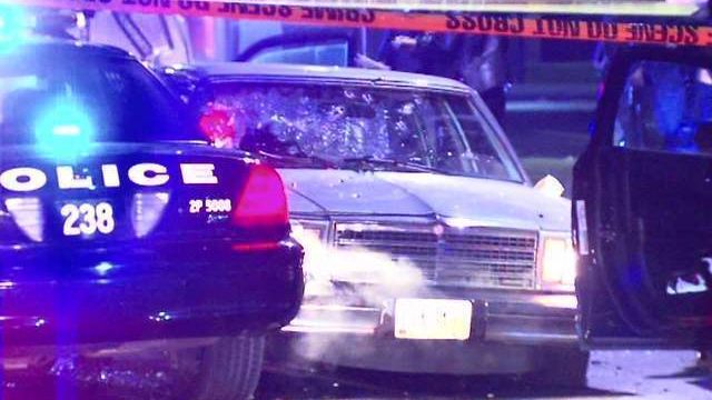 Picture of car with gunshots through windshield.