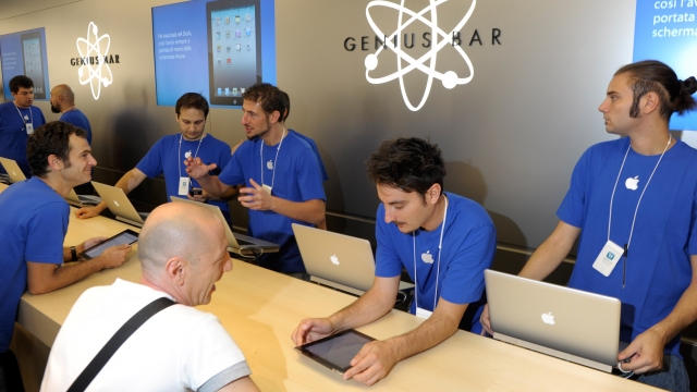 Staff attend the Genius Bar during the Apple store opening at Via Rizzoli on September 17, 2011 in Bologna, Italy.