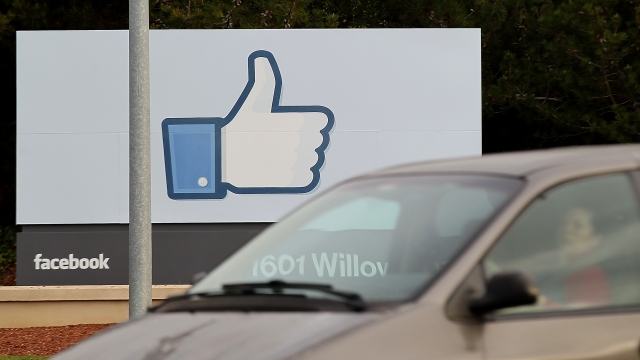 A sign with the 'like' symbol stands in front of the Facebook headquarters.