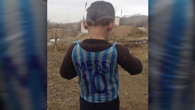 This photograph taken on January 24, 2016 and provided by the family of Afghan boy and Lionel Messi fan Murtaza Ahmadi, 5, shows him wearing a plastic bag jersey in Jaghori district of Ghazni province.