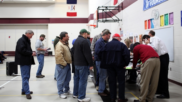 Voters wait in line to register at the Ankeny 9 Republican caucus on January 3, 2012 in Ankeny, Iowa.