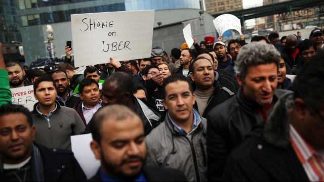 Protesters at Uber office in New York City voice frustration with the company's fare cuts.
