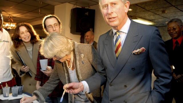 Prince Charles, Prince of Wales (R) and Duchess of Cornwall Camilla Parker-Bowles (C) help paint a mural inside of Heavenly Hall Church as part of a two-day trip to the U.S. January 27, 2007 in Philadelphia, Pennsylvania.