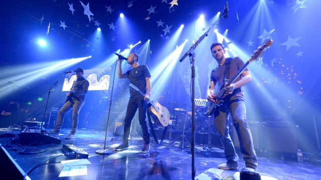 Musicians Jonny Buckland, Chris Martin, Will Champion and Guy Berryman of Coldplay perform onstage during their iHeartRadio Album Release Party at the iHeartRadio Theater Los Angeles on May 16, 2014 in Burbank, California. Streaming Live on Yahoo Screen and Clear Channel stations across the country.
