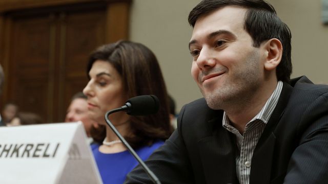 Martin Shkreli, former CEO of Turing Pharmaceuticals LLC., smiles while flanked by Nancy Retzlaff, chief commercial officer for Turing Pharmaceuticals LLC., during a House Oversight and Government Reform Committee hearing on Capitol Hill, February 4, 2016 in Washington, DC. Shkreli invoked his 5th Amendment right not to testify to the committee that is examining the prescription drug market. (Photo by Mark Wilson/Getty Images)