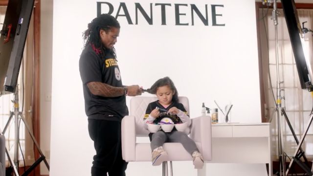 DeAngelo Williams braids his daughter's hair in a Pantene ad for the campaign "Strong Is Beautiful."