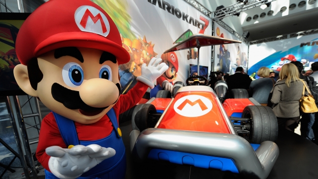 Nintendo game character Mario stands next to the new gamer-themed car built by West Coast Customs on November 17, 2011 in Los Angeles, California.