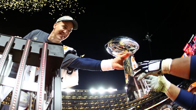 Peyton Manning #18 of the Denver Broncos is handed the Vince Lombardi Trophy after defeating the Carolina Panthers during Super Bowl 50 at Levi's Stadium on February 7, 2016 in Santa Clara, California. The Broncos defeated the Panthers 24-10.