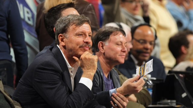 Stan Kroenke sits courtside at the Denver Nuggets game.