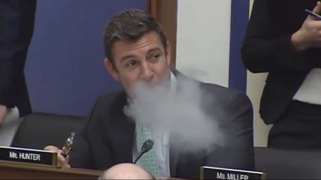 Rep. Duncan Hunter from California pulls from a vaporizer during a Transport Committee meeting.