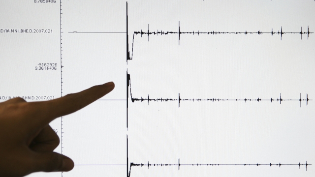 A Meteorology and Geophysics Agency (BMG) officer points to a screen graphic at the BMG office of a 6.5-magnitude earthquake that struck North Sulawesi province on January 21, 2007 on the island of Sulawesi, Indonesia.