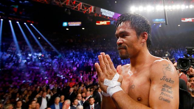 Manny Pacquiao gestures to the crowd after losing to Floyd Mayweather Jr. in their welterweight unification championship bout on May 2, 2015 at MGM Grand Garden Arena in Las Vegas, Nevada.