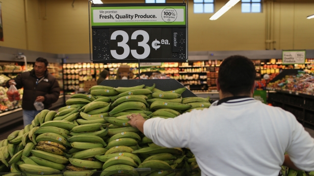 A Wal-Mart employee stocks bananas.