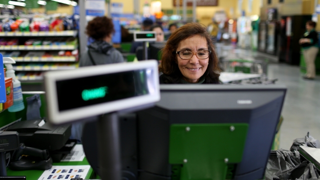 Wal-Mart employee Blanca Mojita rings up a customers purchases at a Walmart store on February 19, 2015 in Miami, Florida.