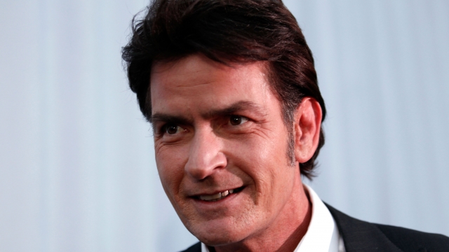 Charlie Sheen smiles in a photo from a 2011 event.
