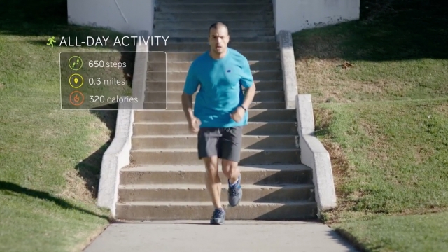 A man runs with a Fitbit to track his activity.