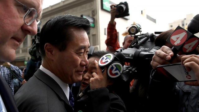 Former state Sen. Leland Yee surrounded by media after leaving courtroom in San Francisco.