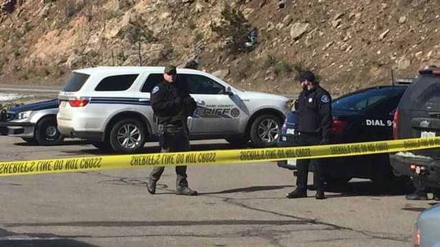 Officers near the scene of a shooting that killed one deputy and injured two others in Bailey, Co.