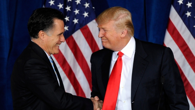 Mitt Romney and Donald Trump shake hands during a news conference held by Trump to endorse Romney.