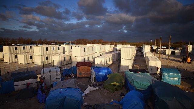 Clouds hover over a new migrant camp under construction near the camp known as 'The Jungle'