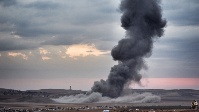 Smoke and dust rise over Syrian town of Kobani after an airstrike, as seen from the Mursitpinar crossing on the Turkish-Syrian border in the southeastern town of Suruc in Sanliurfa province, October 23, 2014.