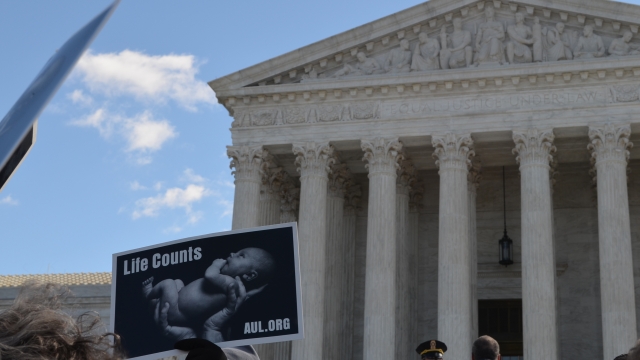 Protesters gather outside the U.S. Supreme Court on March 2 as justices hear arguments in a Texas abortion case.
