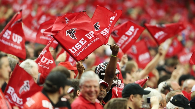 Atlanta Falcons fans wave flags during the NFC Divisional Playoff Game against the Seattle Seahawks at Georgia Dome.