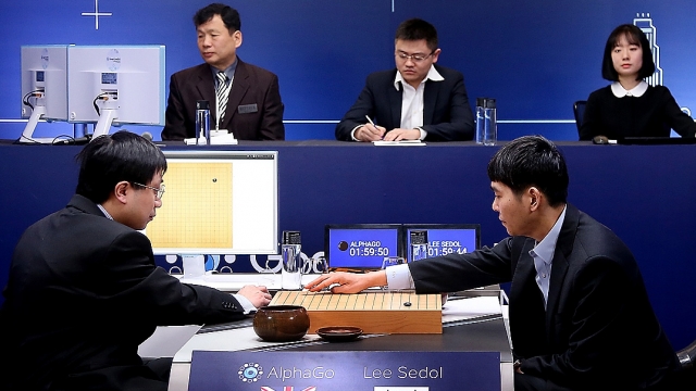 In this handout image provided by Google, South Korean professional Go player Lee Se-Dol (R) puts his first stone against Go