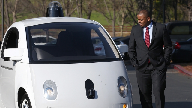 U.S. Transportation Secretary Anthony Foxx inspects a Google self-driving car at the Google headquarters on February 2, 2015