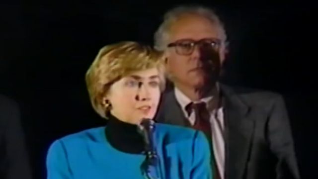 Sen. Bernie Sanders stands behind Former Secretary of State Hillary Clinton in 1993 as she speaks about health care reform.
