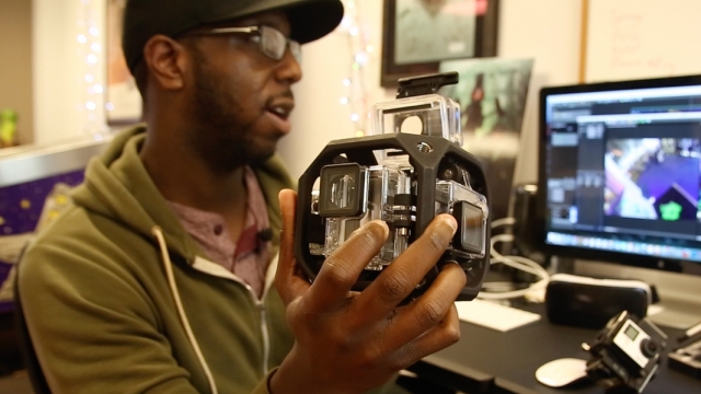 A VR producer handles a waterproof camera rig for shooting 360-degree video.