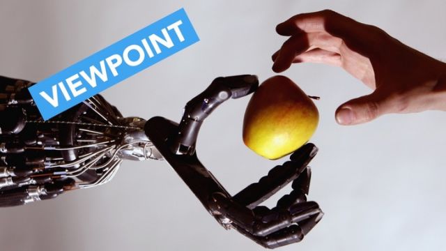 A robot holds an apple