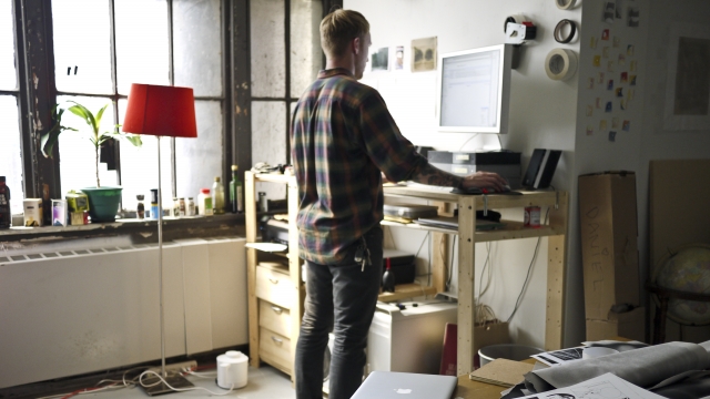 A person using a standing desk.