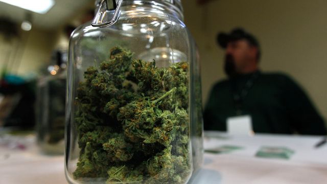 A jar of marijuana sits on a table at an expo in Colorado.