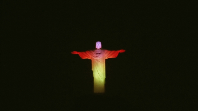 The Christ the Redeemer statue in Rio de Janeiro lit up in the colors of the Belgium flag.