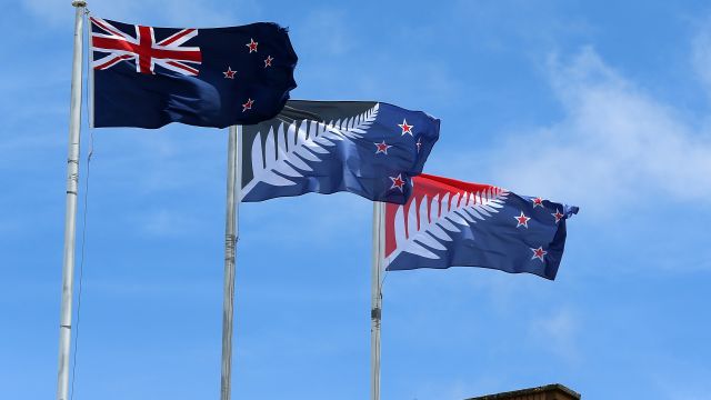 The current New Zealand flag (L) and two other competing flags fly on a building in New Lynn, Auckland.