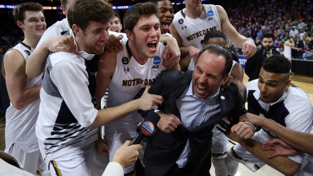 Head coach Mike Brey of Notre Dame celebrates with his team after defeating Wisconsin in the Sweet 16.