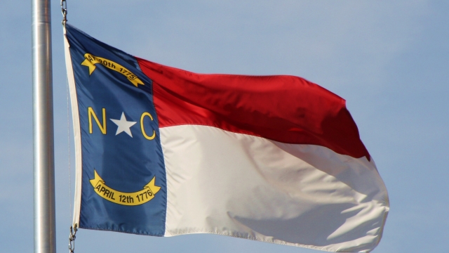 The state flag of North Carolina flutters in the wind.