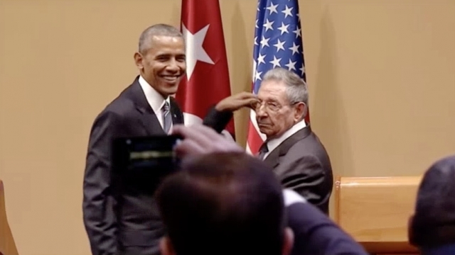 Barack Obama and Cuban President Raul Castro attempt to shake hands