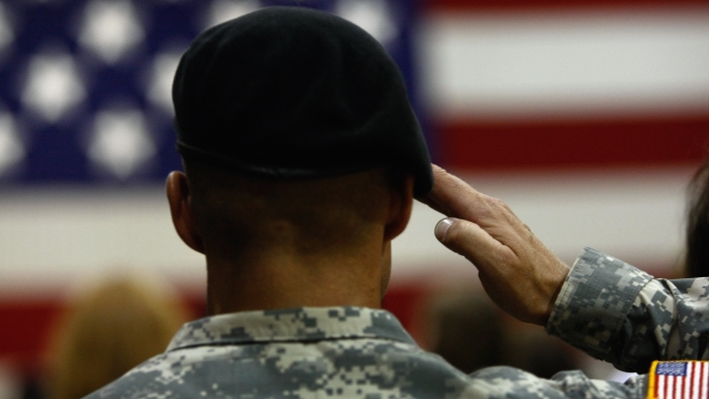 A U.S. Army soldier salutes during the national anthem